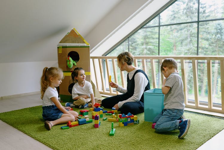 A Teacher Playing With The Kids In The School