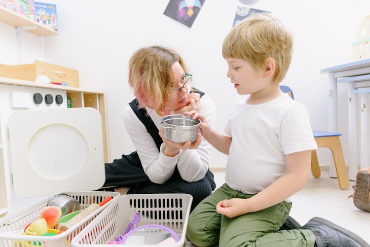 Woman With The Little Boy Sitting On The Floor