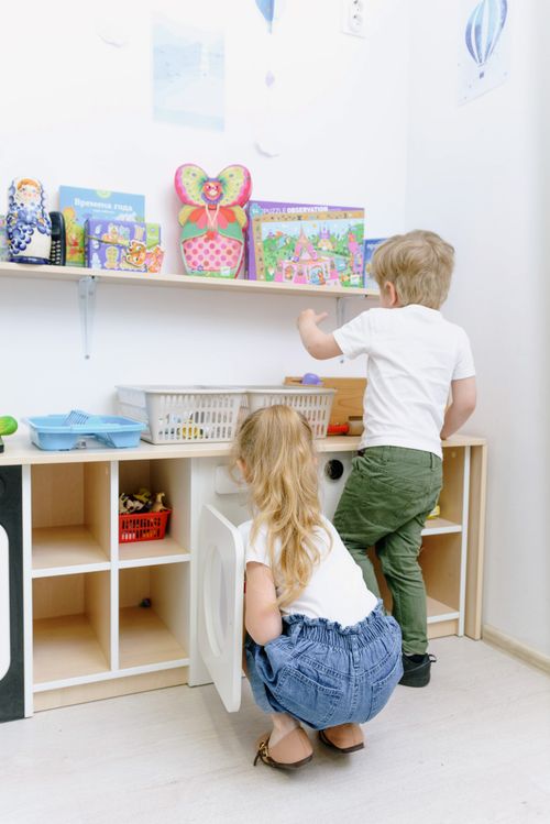 Free Two children playing with toys in a cozy indoor setting. Stock Photo