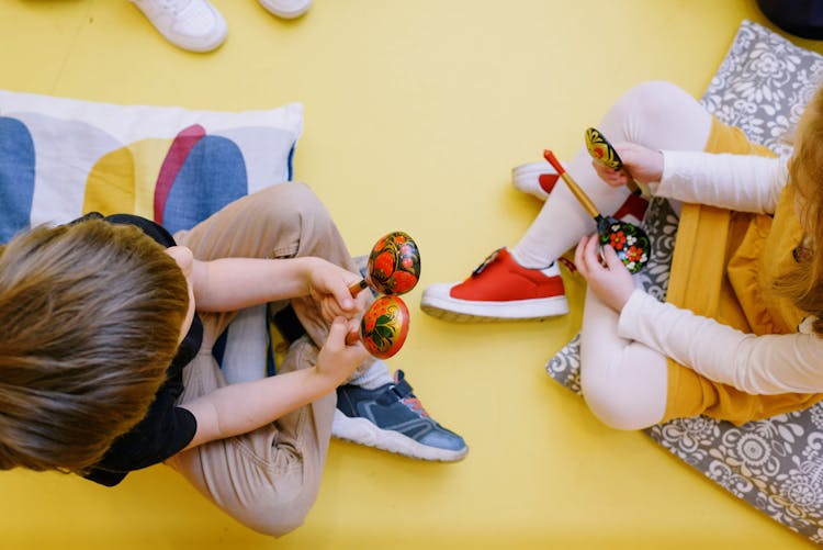 Kids Playing With Rattle Musical Instrument