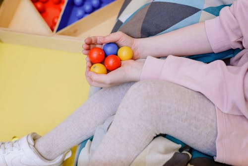 Free Close-Up Shot of a Person Holding Plastic Balls Stock Photo