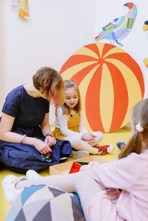 Free Kids engaging with toys in a vibrant kindergarten, fostering learning and play. Stock Photo