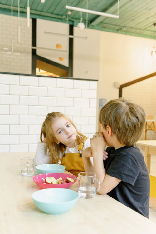 A Boy and a Girl Eating Snacks