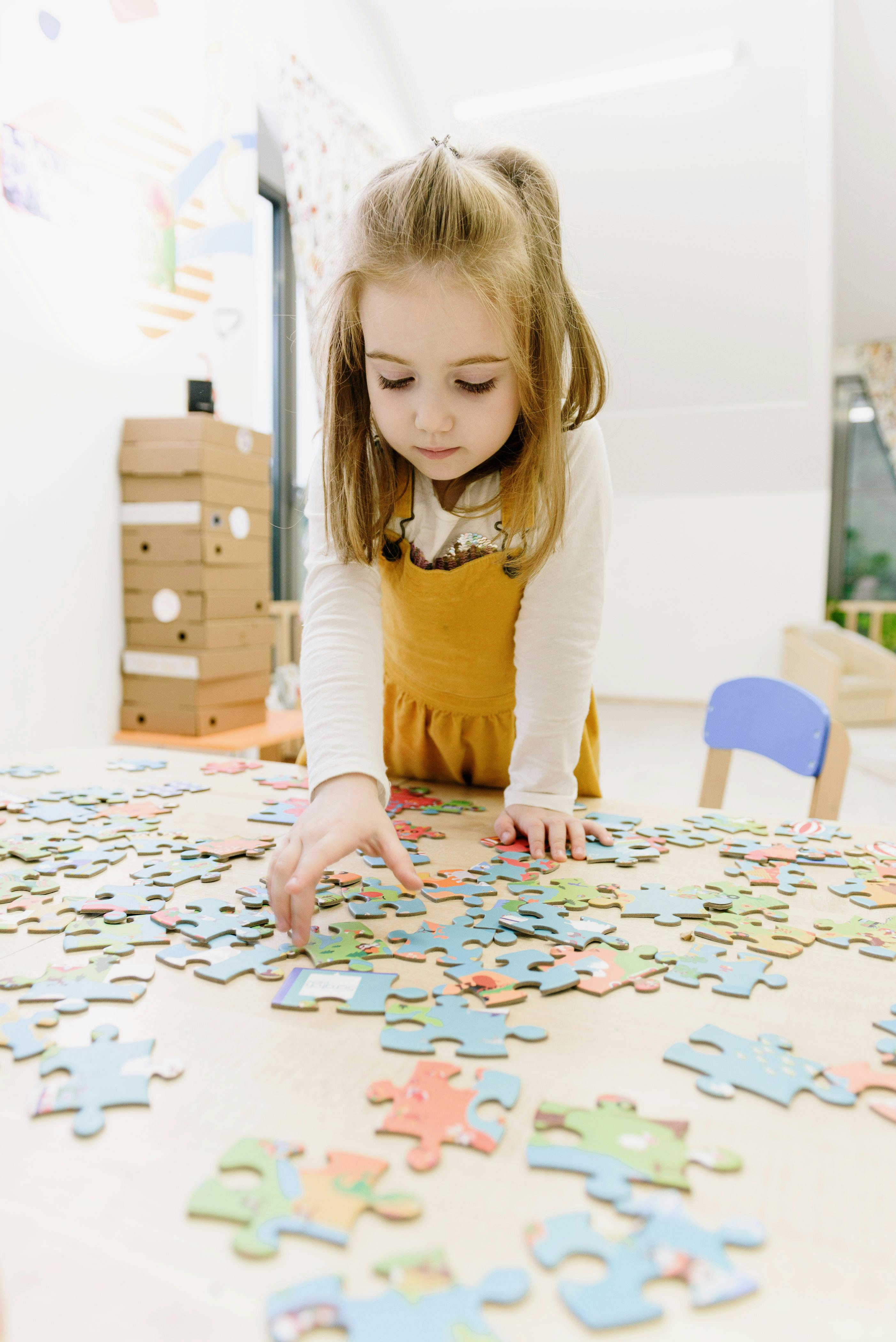 girl in yellow dress puzzling