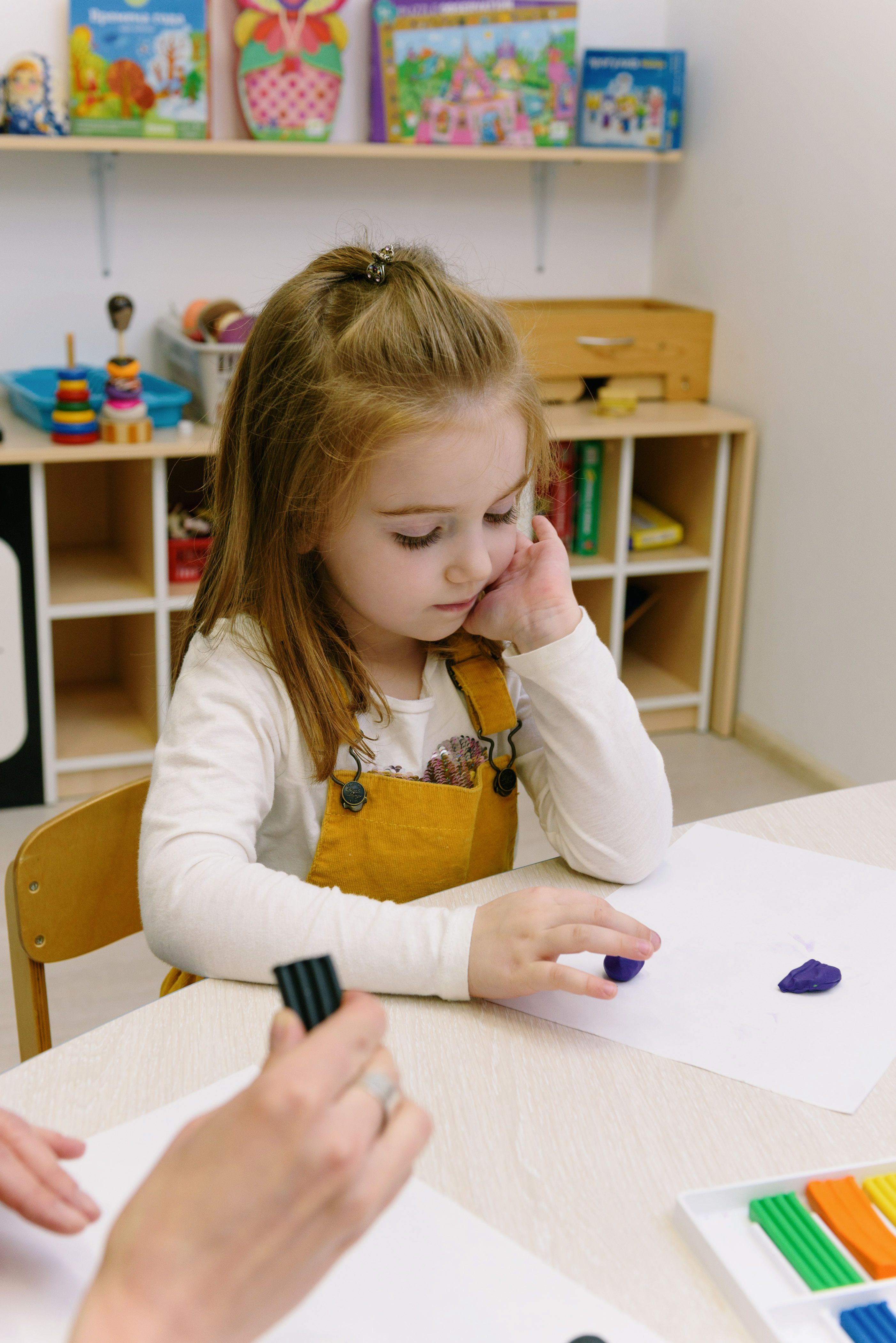 Child engaged in creative activity-based therapy session