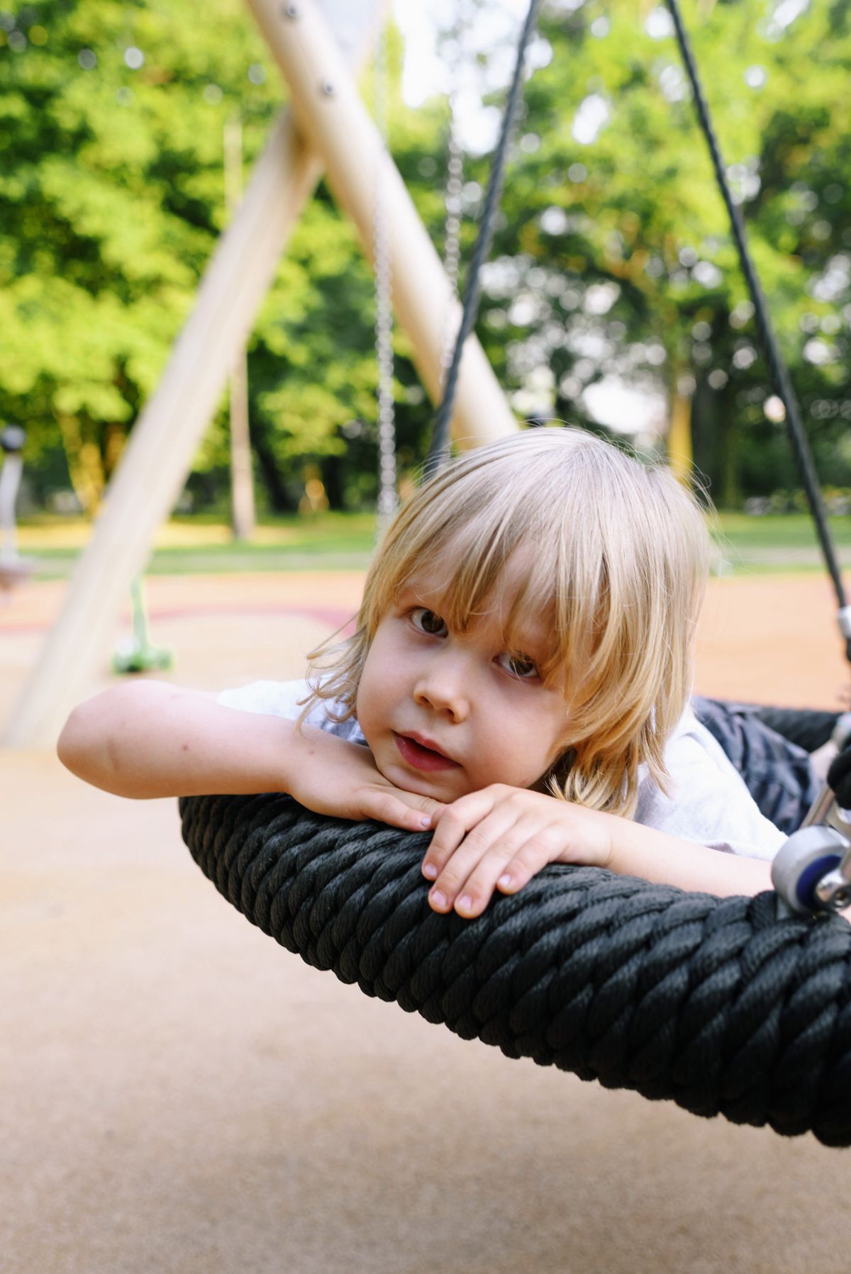 Child resting on a tyre swing