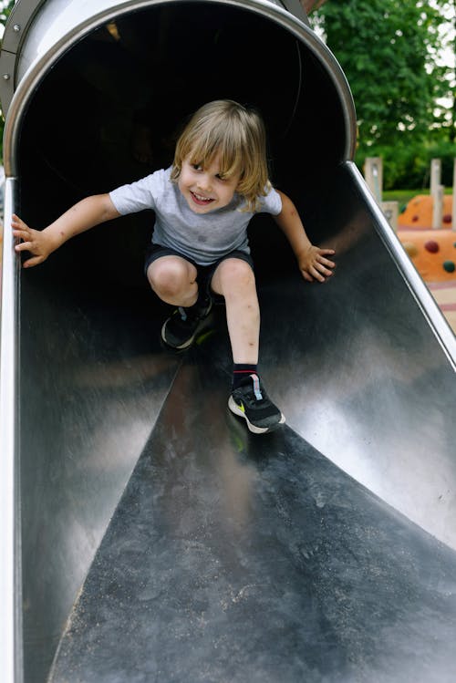 Boy Sliding Down and Smiling