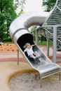Boy Sliding Down on Playground
