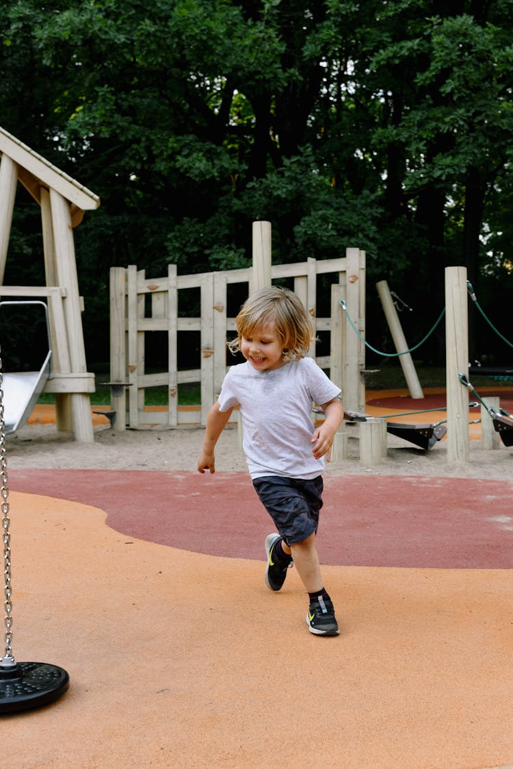 A Boy Running In The Playground