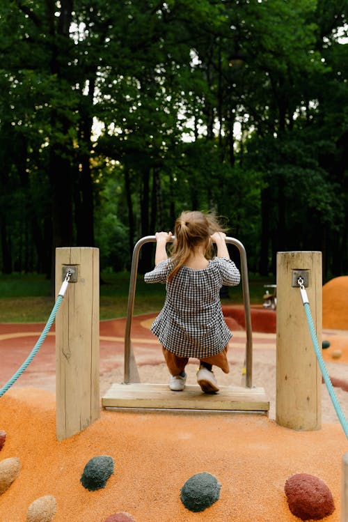 A Child Playing on Outdoor Playground