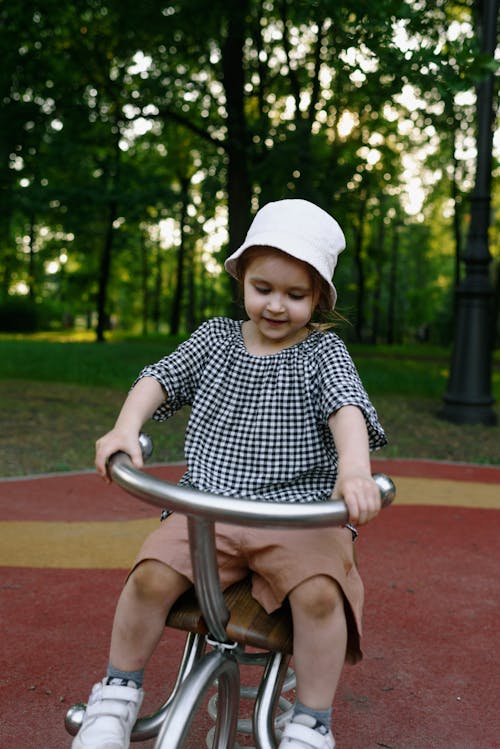 Girl Riding Bicycle on Playground