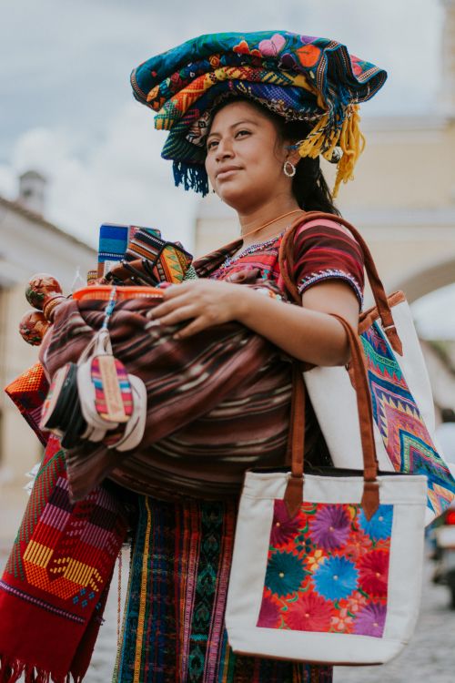 Free Local street vendor selling colorful textiles in Antigua Guatemala. Stock Photo