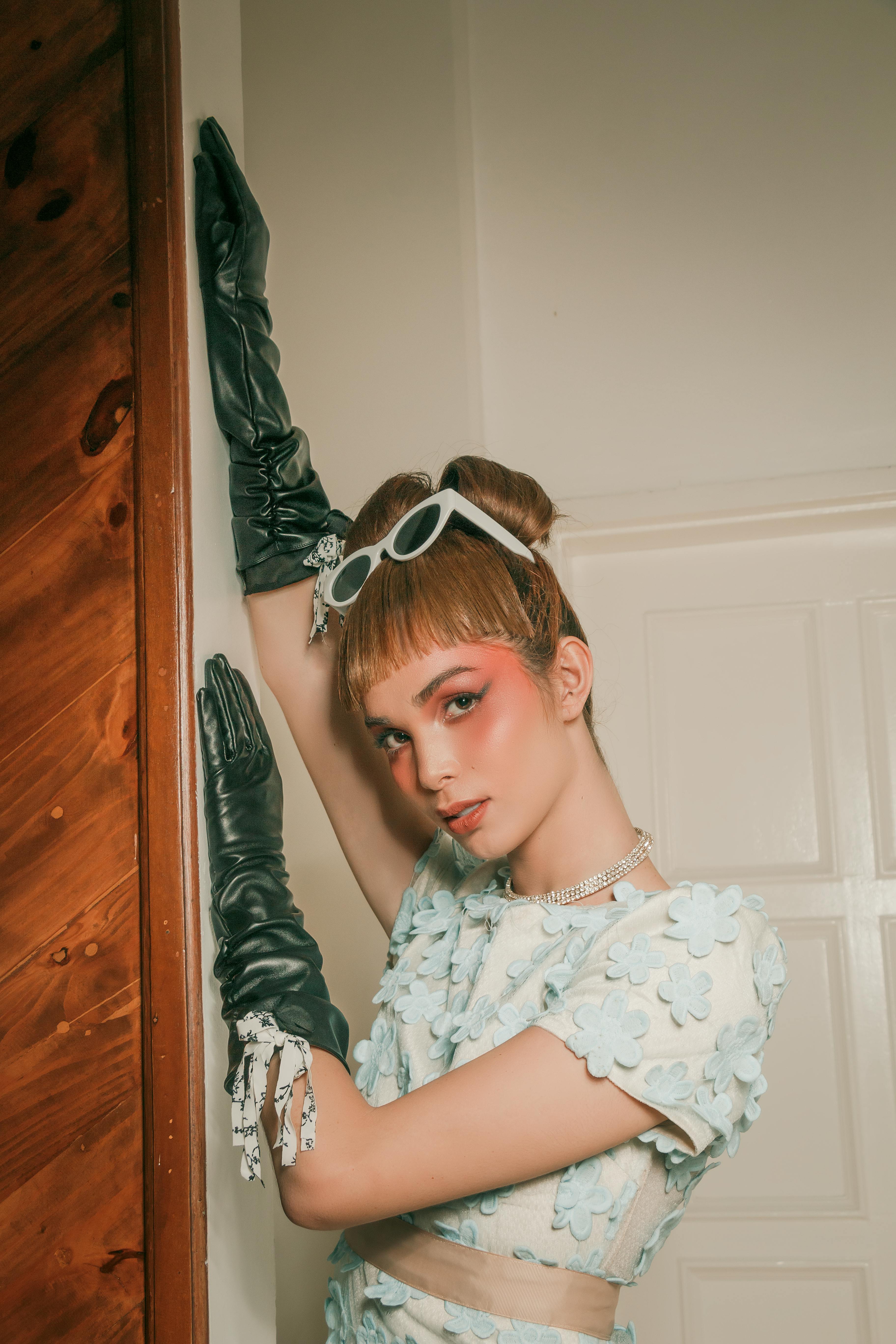 woman in blue floral clothing with long black gloves