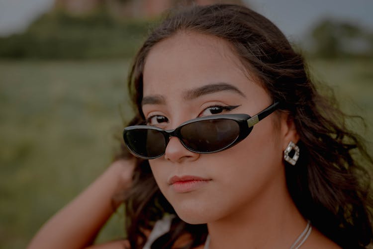 Woman Wearing Black Shades With Winged Eyeliner