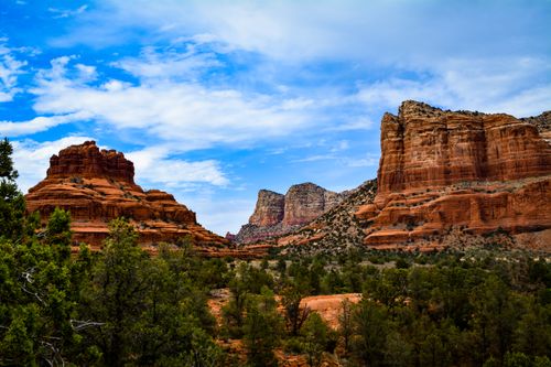 Free Breathtaking view of Sedona's iconic red rock formations under a vibrant blue sky. Stock Photo