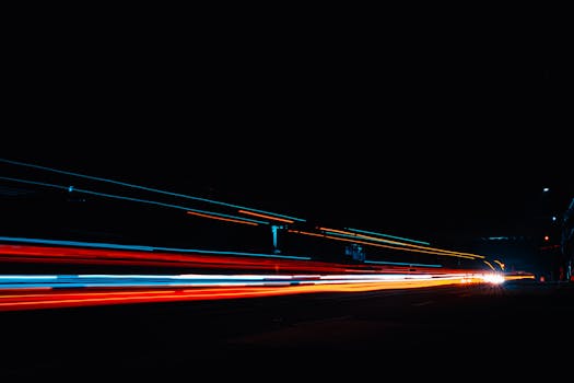 Vibrant light streaks from vehicle traffic captured at night with long exposure.