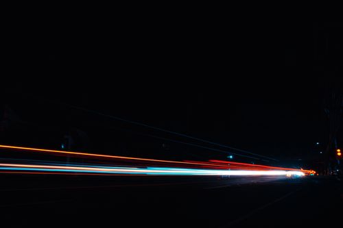 Free Vibrant streaks of light in a night cityscape showcasing dynamic motion. Stock Photo