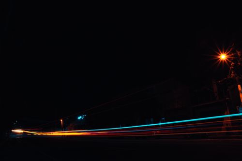 Free Dynamic light trails captured at night on a city street, showcasing urban energy. Stock Photo