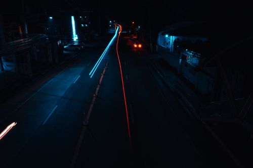 Free Long exposure night shot capturing dynamic light trails on an urban street, showcasing the motion and vibrancy of city life. Stock Photo