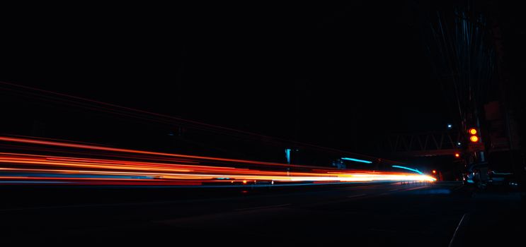 Captivating long exposure photo of night traffic light trails on an urban street.