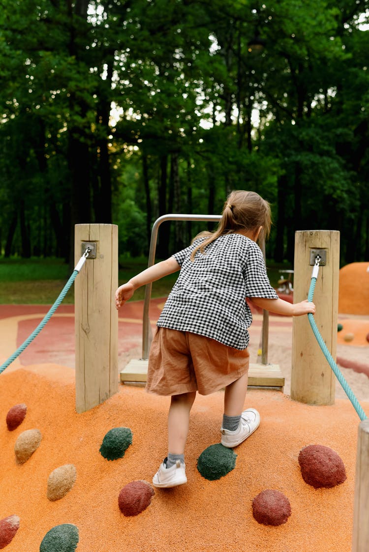 Girl Playing At The Playground