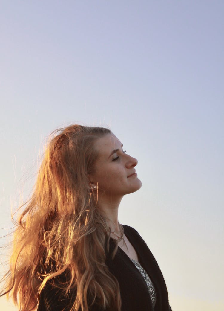 Woman With Messy Hair Under Blue Sky