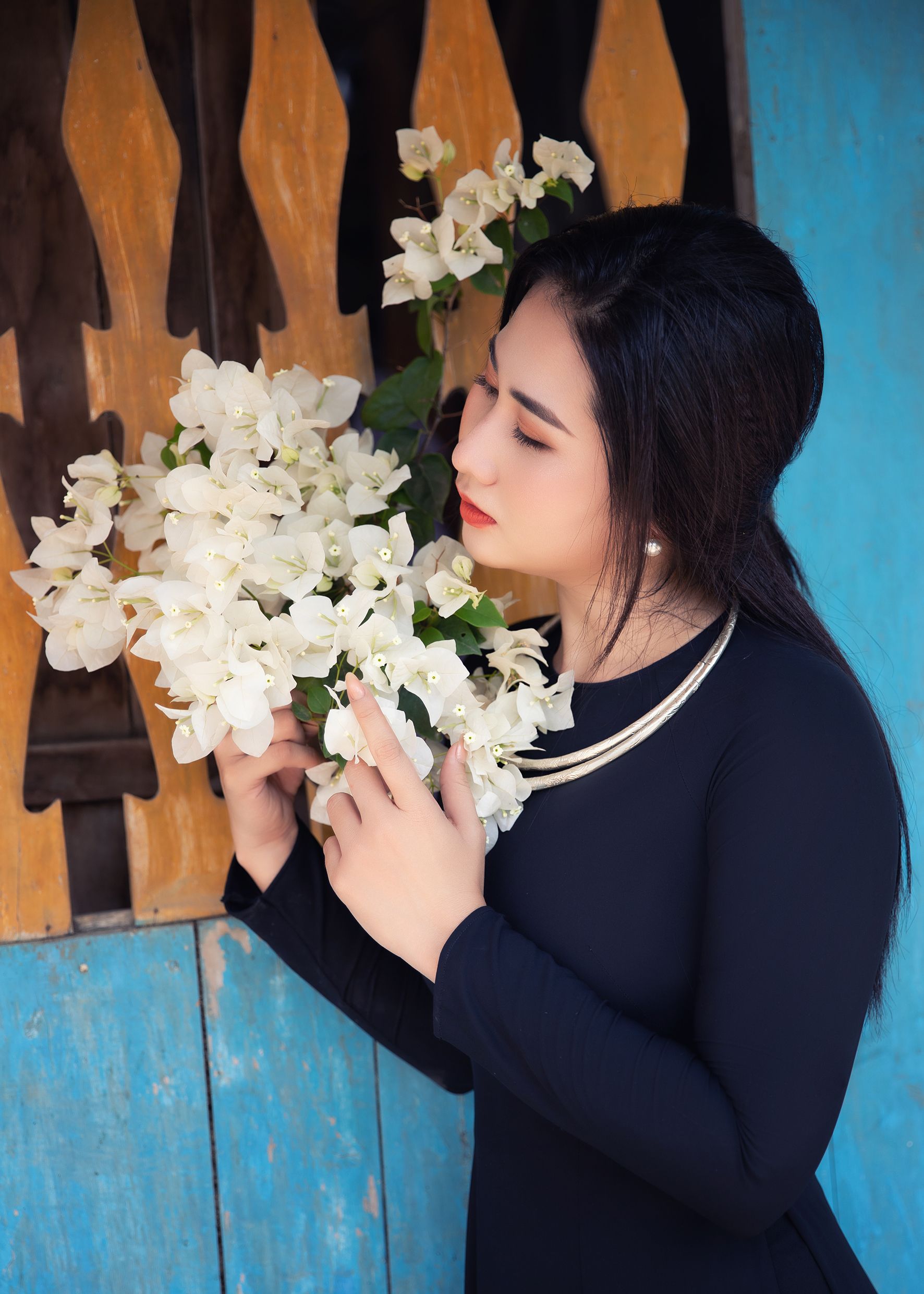Woman in Black Dress Posing with White Flowers · Free Stock Photo