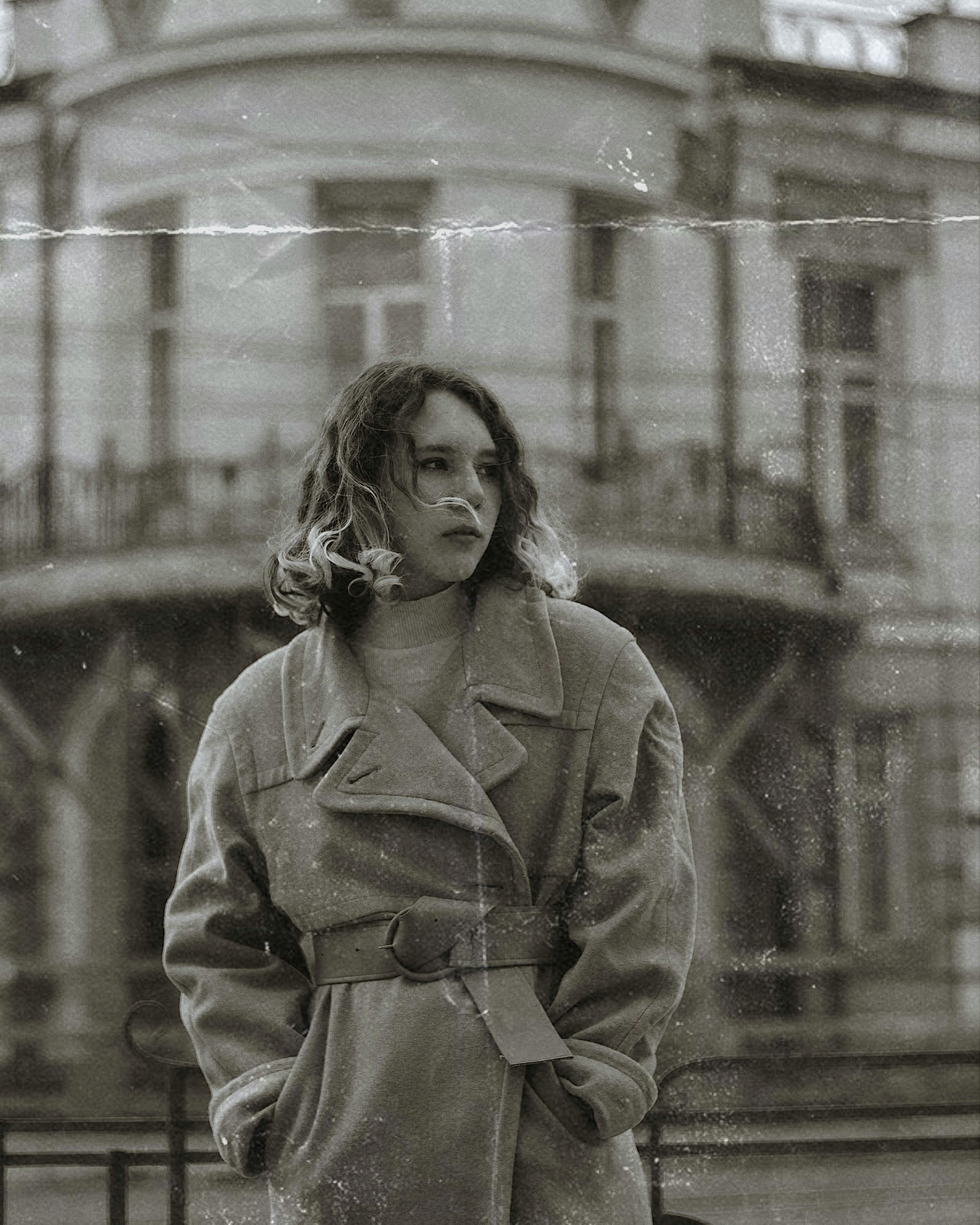 vintage photo of woman in coat with hands in pockets