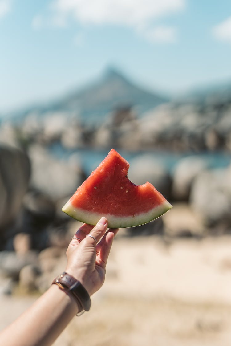 Person Holding A Slice Of Watermelon