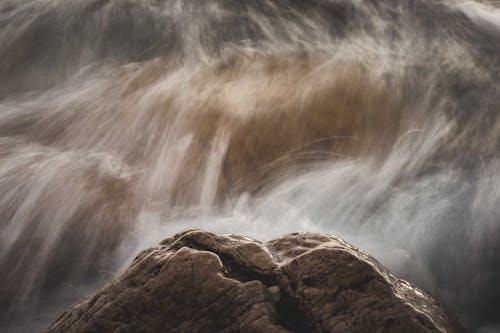 Free Brown Rock with White Splashes of Water Stock Photo