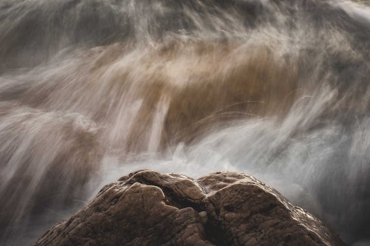 Brown Rock With White Splashes Of Water