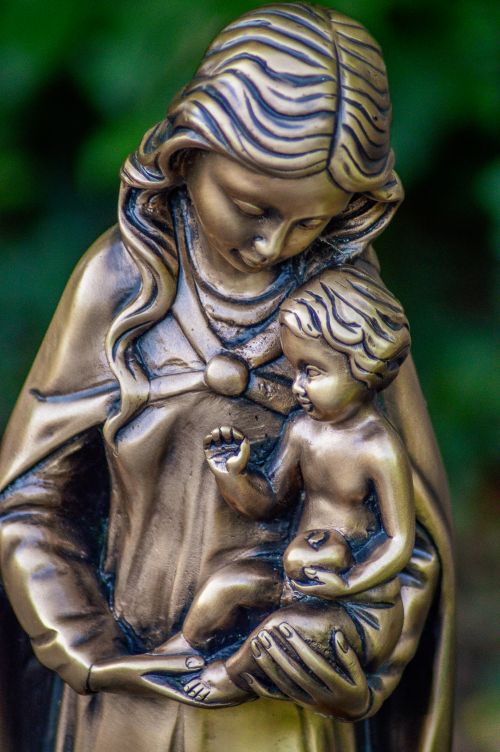 Free Detailed close-up of a bronze sculpture depicting a mother and child. Stock Photo