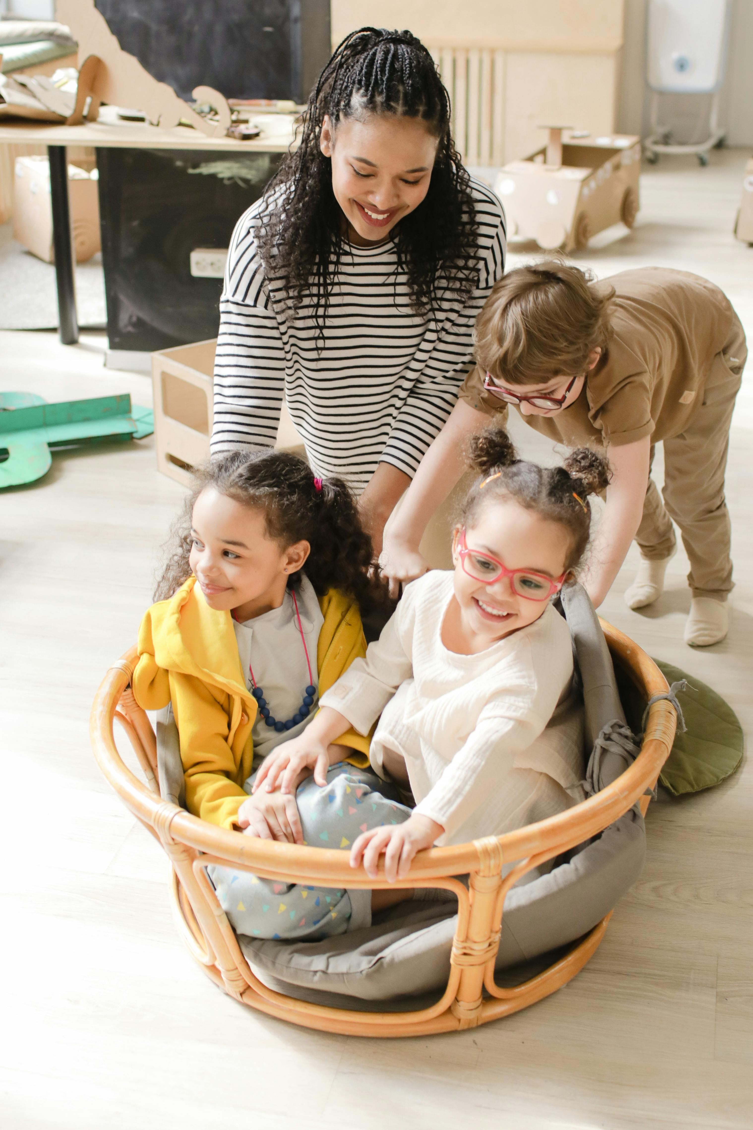 teacher playing with her students