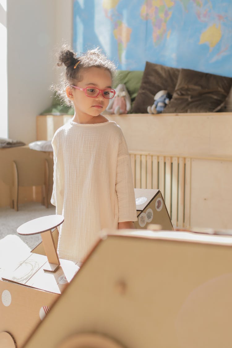 A Girl Looking At The Paper Car 