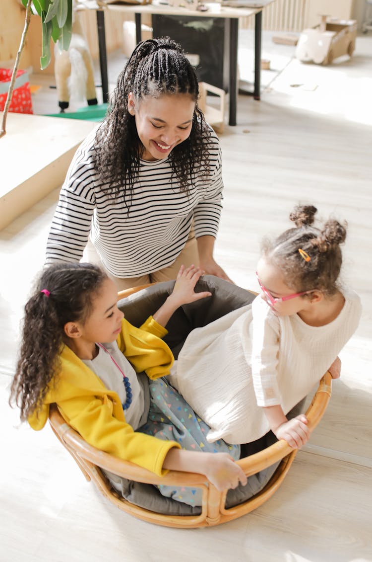 Girls Playing Together While Inside A Basket