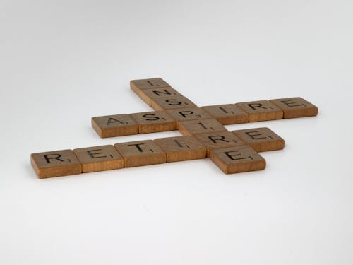 Brown Wooden Scrabble Tiles on White Surface