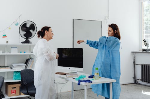 Women Having a Conversation while Wearing their PPE