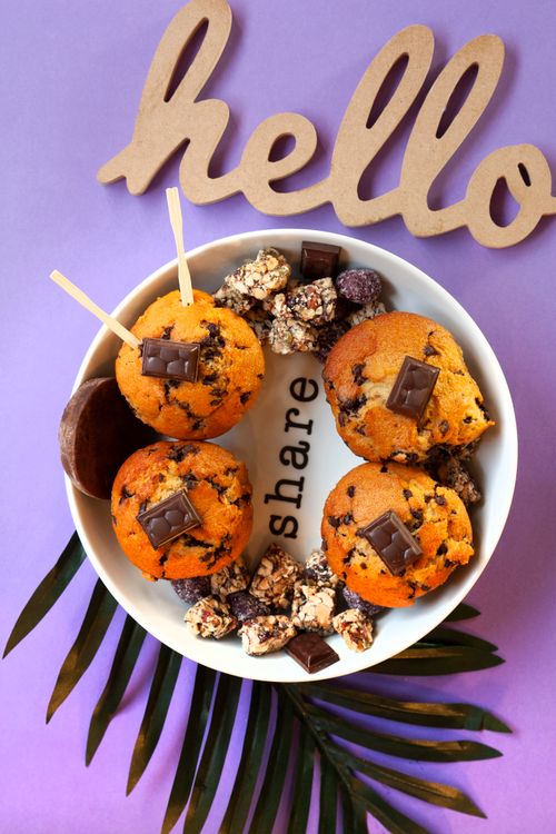 Free Top view of chocolate chip muffins and snacks on a decorative plate. Stock Photo