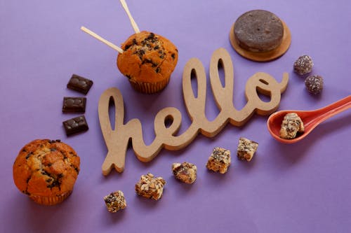 Chocolates and Muffins on Purple Surface