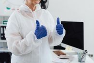 Woman in White Long Sleeve Shirt Holding Blue Plastic Cup