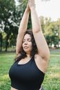 Woman in Black Tank Top Raising Her Hands