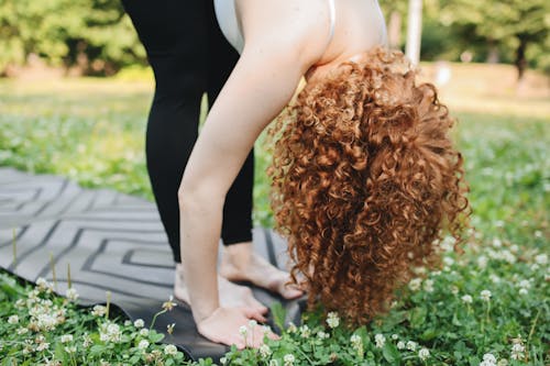 Free Woman Doing Stretching on the Grass Stock Photo