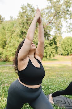 Plus size woman in yoga pose outdoors promoting fitness and healthy living.