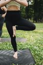 Woman in Black Leggings and Black Tank Top on Black Yoga Mat