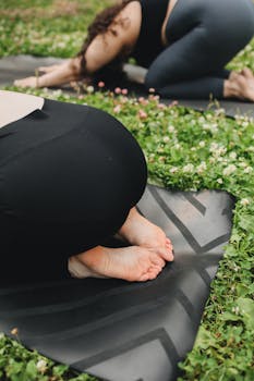 Relaxing outdoor yoga session focusing on feet position on mat.