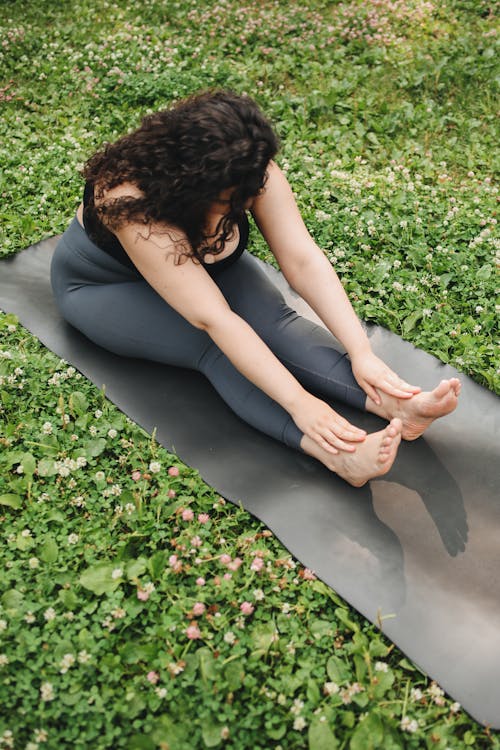 Woman in Black Brassier and Gray Leggings doing Yoga