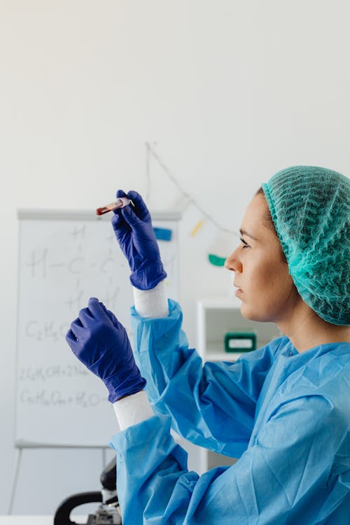 Free Woman Looking at a Blood Sample on a Test Tube Stock Photo