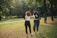 2 Women Kissing on Green Grass Field