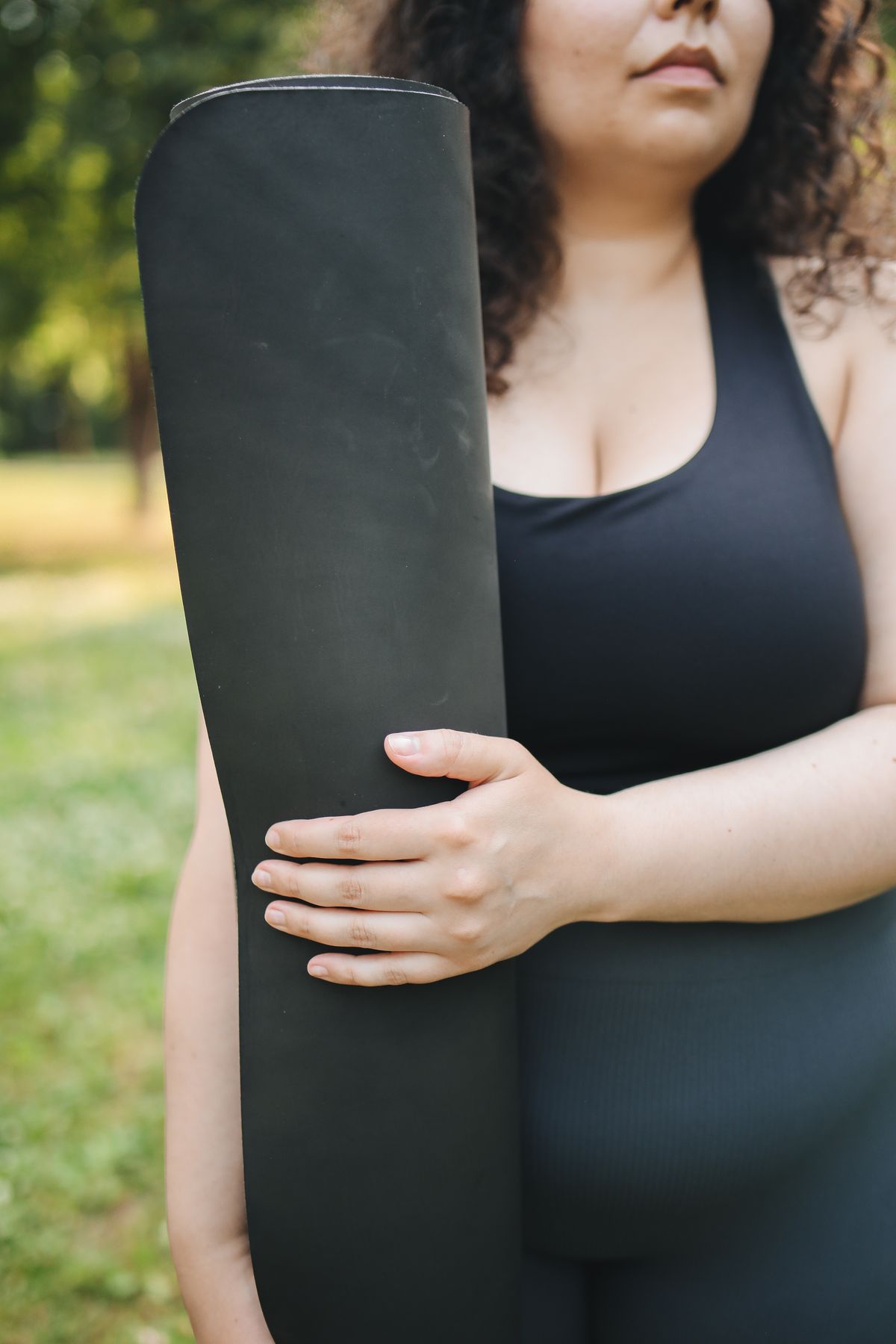 Woman carrying a yoga mat for mobility and wellness training