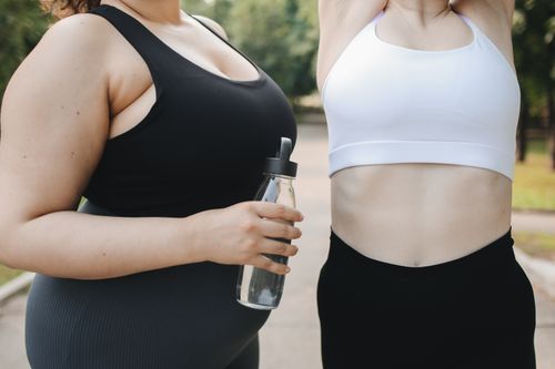 Free Two diverse women in activewear working out outdoors, promoting body positivity and health. Stock Photo